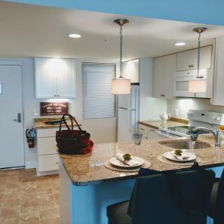 A modern kitchen featuring a well-designed island and contemporary lighting.