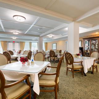 An elegant dining room with neatly arranged tables and chairs.