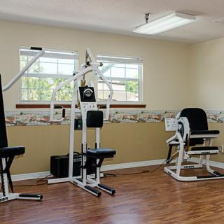 A small gym with exercise machines for workouts.