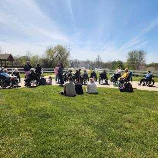 A gathering of people enjoying a sunny day outdoors.