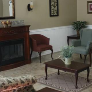 A cozy living room with elegant furniture and a fireplace.