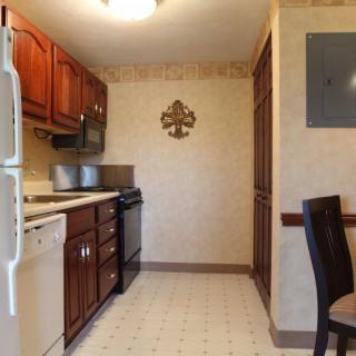 A kitchen with wooden cabinets and standard appliances.