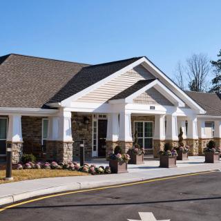 A modern residential or commercial building with a prominent entrance and landscaped surroundings.