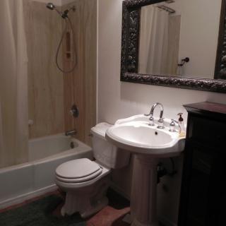 A cozy bathroom with a sink, toilet, and bathtub.