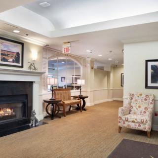 A cozy lobby interior with a fireplace and comfortable seating.