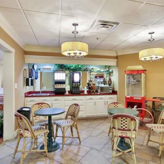 An inviting indoor cafe with seating and a snack bar.