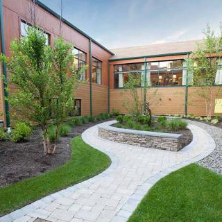 A beautifully landscaped courtyard with a winding pathway and lush greenery.