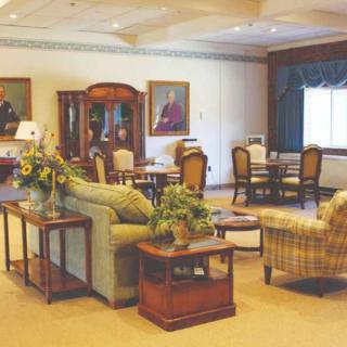 A spacious and elegantly furnished living room with comfortable seating and a dining area.