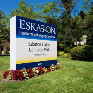 Sign for Eskaton Lodge Cameron Park surrounded by well-maintained landscaping.