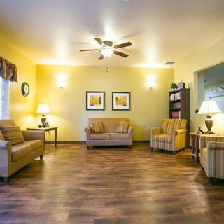 A cozy living room with warm lighting and comfortable seating.