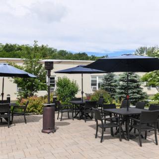 A serene outdoor patio area featuring tables and umbrellas, ideal for relaxation.