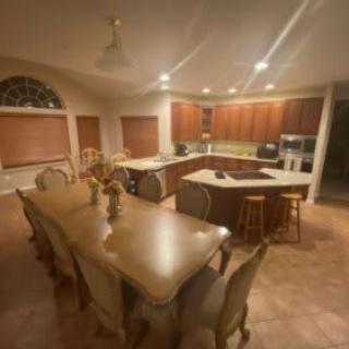 Spacious kitchen and dining area with a large table and island counter.