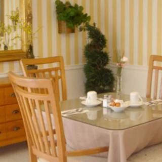 A cozy dining room with a neatly set table and elegant decor.