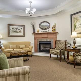 A cozy living room featuring elegant furniture, a fireplace, and tasteful artwork.