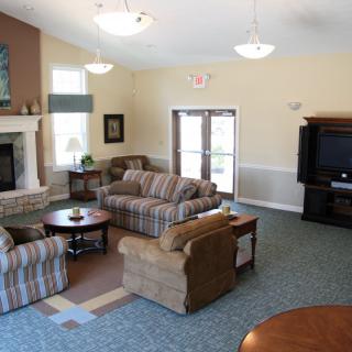 A cozy living room with sofas, a coffee table, and a fireplace.
