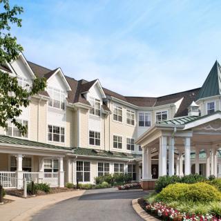 Elegant residential building with landscaped entrance.