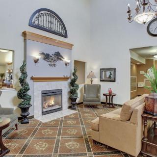 A luxurious hotel lobby featuring comfortable seating, a warm fireplace, and elegant decor.