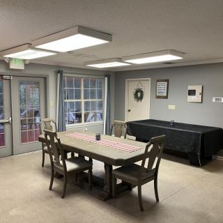 A cozy dining area with a pool table and ample lighting.