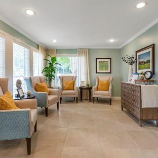A cozy living room with comfortable armchairs, soft lighting, and decorative artwork.