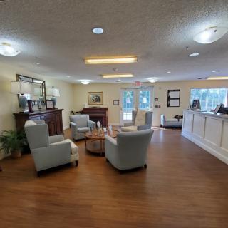 A cozy lobby with comfortable seating and a reception desk.