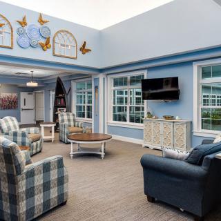 A cozy living room with comfortable seating and large windows.