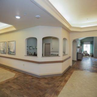 A modern lobby hallway with artwork on the walls and stylish lighting.
