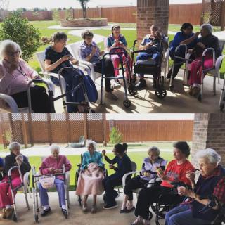 A joyful gathering of seniors enjoying time together outdoors.