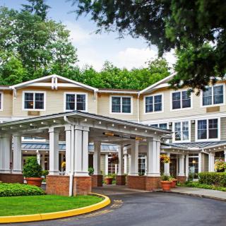 A well-maintained building with a welcoming entrance surrounded by greenery.