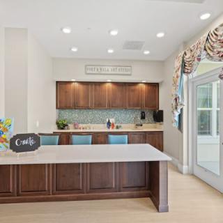 A modern kitchen featuring a large island with seating, sleek cabinetry, and contemporary appliances.