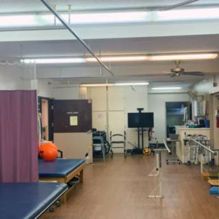 A physical therapy room equipped with exercise beds and equipment.