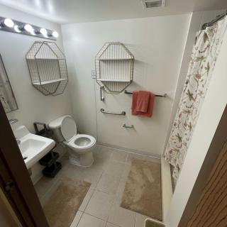 A clean and organized bathroom with essential fixtures and decor.