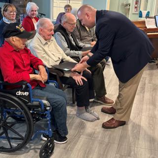 An engaging moment during a community event, highlighting interaction between participants and a speaker.