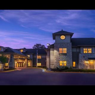 A beautifully lit hotel exterior during twilight.