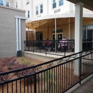 A view of a patio area outside a building where people are gathered.