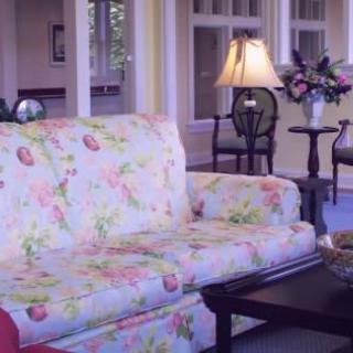 A cozy living room with a floral patterned sofa and elegant decor.