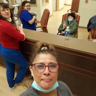 A candid moment captured in a healthcare setting, featuring a group of individuals enjoying each other's company.