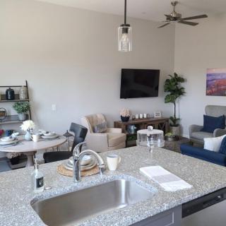A modern open-concept kitchen and living room with stylish furnishings and decor.
