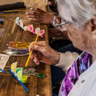 Seniors engaging in a painting and crafting activity.