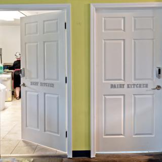 Two white doors labeled 'RESTROOM' leading to different bathroom facilities in a home.