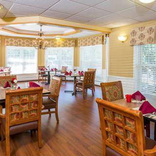A bright and elegantly decorated dining room with neatly arranged tables and chairs.
