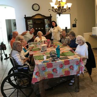 A joyful gathering of seniors enjoying their time together at a care home.