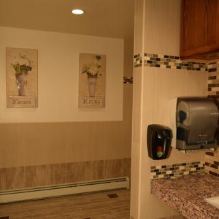 A well-decorated bathroom interior with a sink and hand dryer.