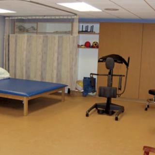 A physical therapy room equipped with exercise and rehabilitation equipment.