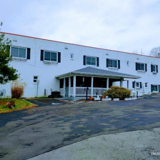 A view of a two-story commercial building with a welcoming entrance and landscaped surroundings.