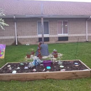 A beautifully arranged garden featuring decorative stones and a mix of plants.