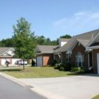 A suburban residential area with brick houses and driveways.