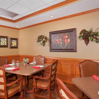 A cozy dining area with elegant decor and neatly set tables.