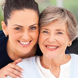 A joyful portrait of two women smiling together.