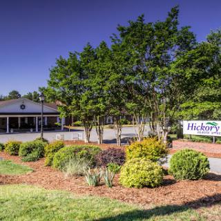A beautifully landscaped commercial property with vibrant flowers and trees.