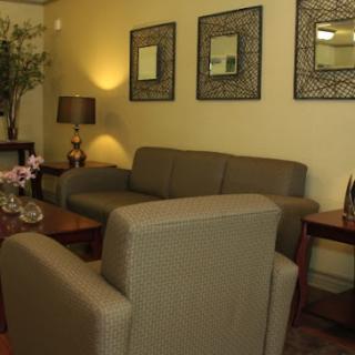 A cozy living room featuring a comfortable sofa, stylish chairs, and decorative elements.